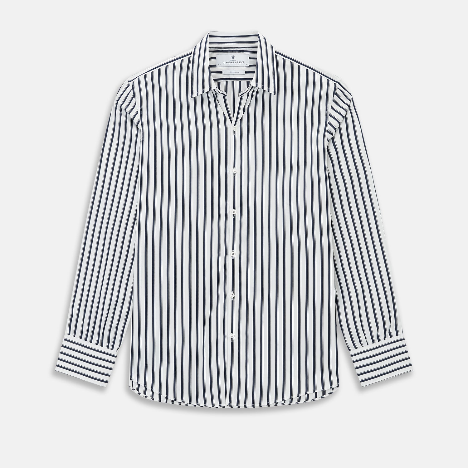 View 1 of product A long-sleeve men’s dress shirt by Turnbull & Asser UK—named SHIRTS RF WINDSOR OPEN CLR BC NAVY STRIPE ON WHTE—featuring classic Windsor open collar styling and navy vertical stripes on a white background, shown on a plain white surface.