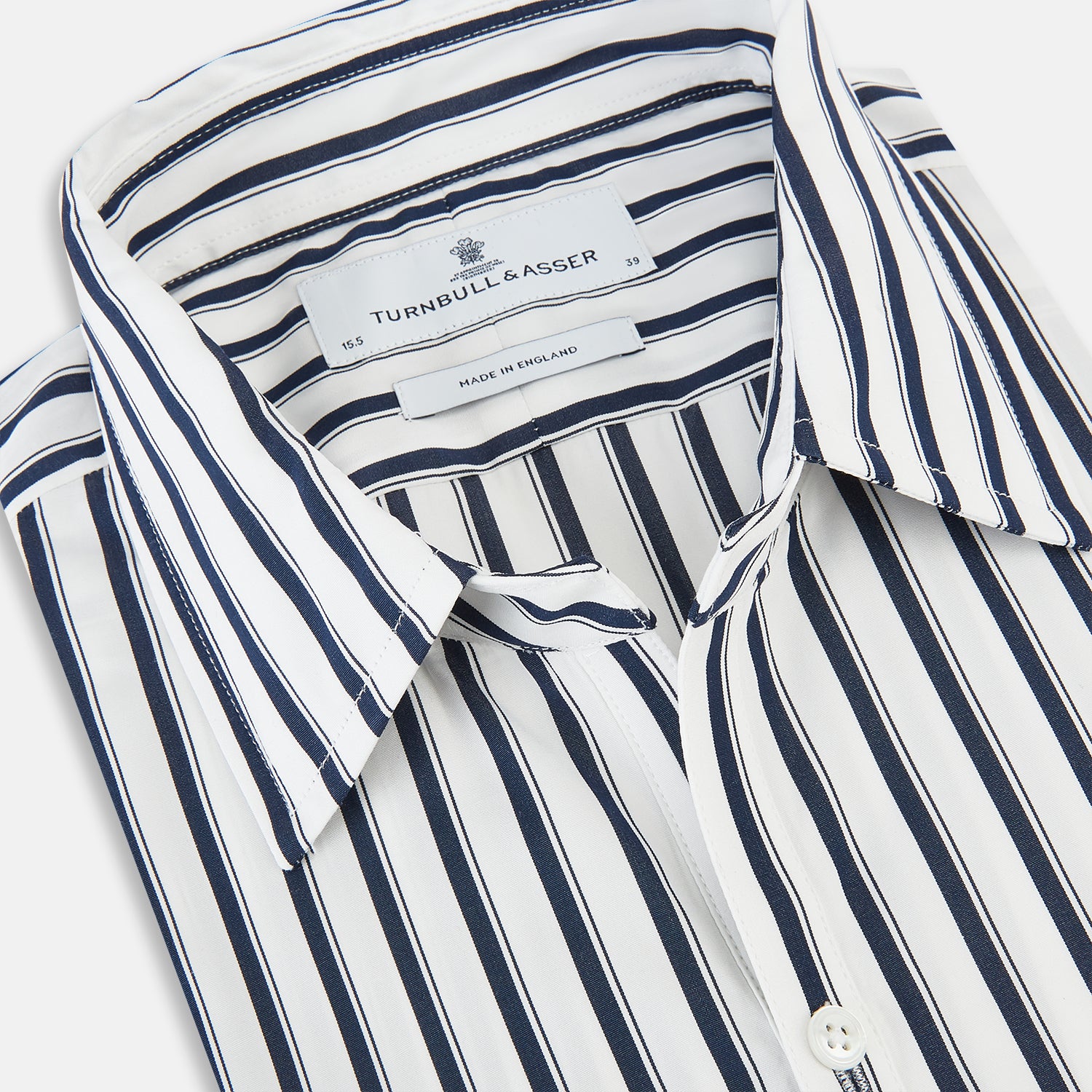 View 2 of product A long-sleeve men’s dress shirt by Turnbull & Asser UK—named SHIRTS RF WINDSOR OPEN CLR BC NAVY STRIPE ON WHTE—featuring classic Windsor open collar styling and navy vertical stripes on a white background, shown on a plain white surface.
