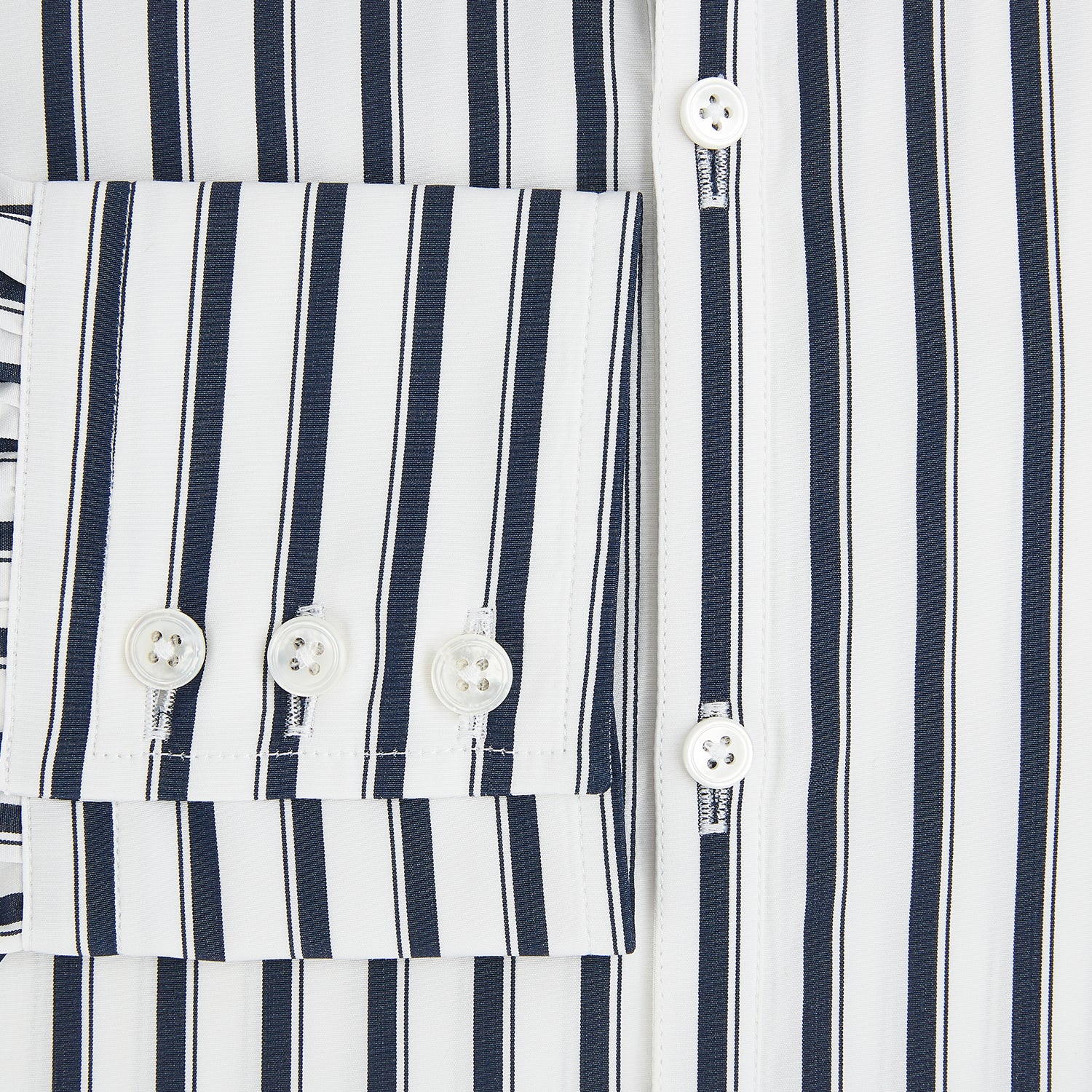 View 4 of product A long-sleeve men’s dress shirt by Turnbull & Asser UK—named SHIRTS RF WINDSOR OPEN CLR BC NAVY STRIPE ON WHTE—featuring classic Windsor open collar styling and navy vertical stripes on a white background, shown on a plain white surface.