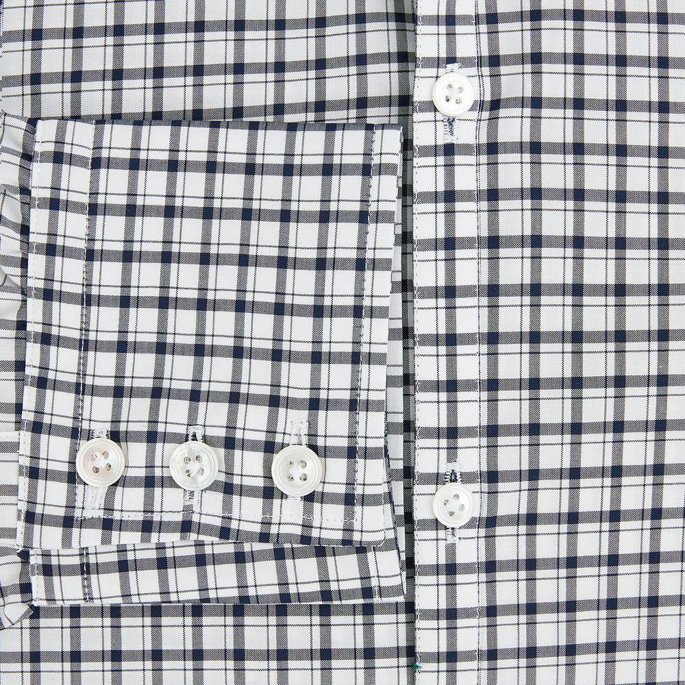 The Chequered Navy on White Windsor Regular Fit Shirt in Cotton by Turnbull & Asser UK features a Windsor collar and long sleeves, showcasing a crisp white background with a navy grid check pattern, displayed on a plain white surface.