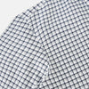 View 6 of product The Chequered Navy on White Windsor Regular Fit Shirt in Cotton by Turnbull & Asser UK features a Windsor collar and long sleeves, showcasing a crisp white background with a navy grid check pattern, displayed on a plain white surface.