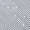 View 7 of product The Chequered Navy on White Windsor Regular Fit Shirt in Cotton by Turnbull & Asser UK features a Windsor collar and long sleeves, showcasing a crisp white background with a navy grid check pattern, displayed on a plain white surface.