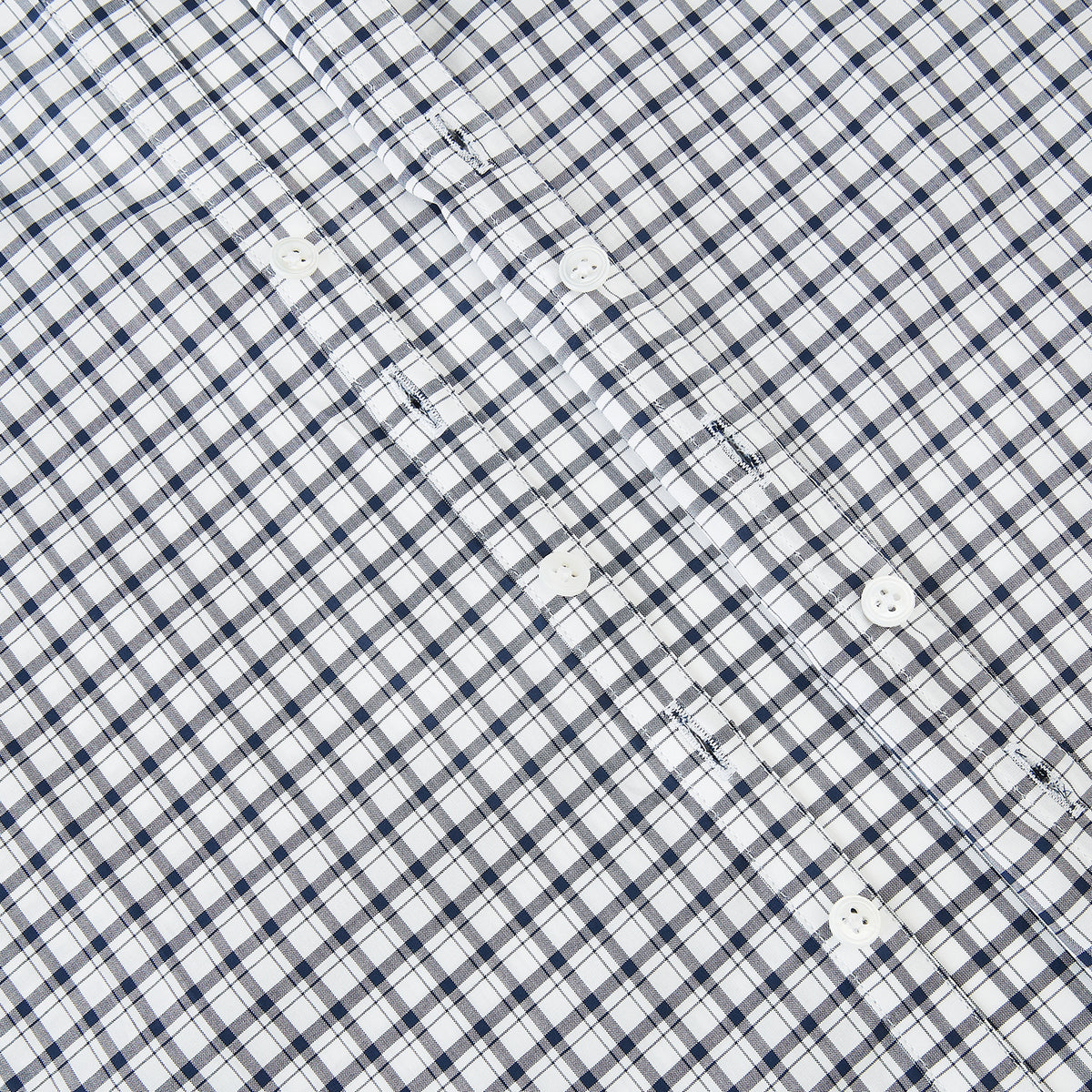 View 7 of product The Chequered Navy on White Windsor Regular Fit Shirt in Cotton by Turnbull & Asser UK features a Windsor collar and long sleeves, showcasing a crisp white background with a navy grid check pattern, displayed on a plain white surface.