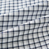 View 8 of product The Chequered Navy on White Windsor Regular Fit Shirt in Cotton by Turnbull & Asser UK features a Windsor collar and long sleeves, showcasing a crisp white background with a navy grid check pattern, displayed on a plain white surface.