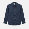View 1 of product The Turnbull & Asser UK White Check on Navy Windsor Shirt features an open collar, button cuffs, and cuffed long sleeves. Showcased against a white background, this shirt presents a navy base adorned with a white grid pattern.