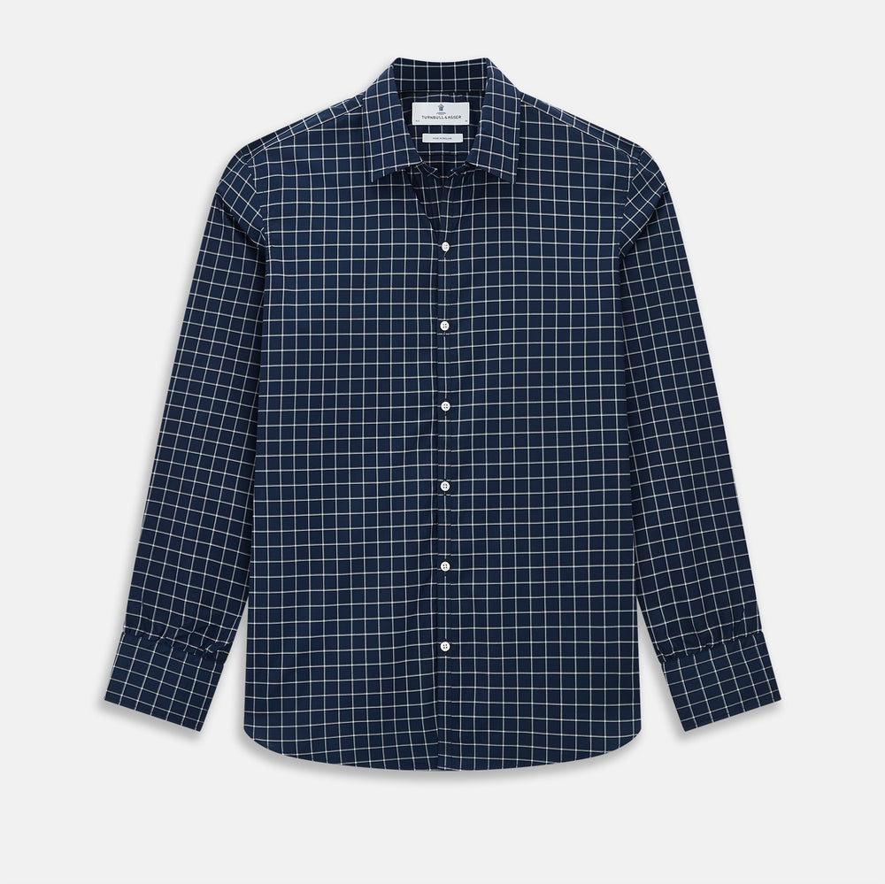 The Turnbull & Asser UK White Check on Navy Windsor Shirt features an open collar, button cuffs, and cuffed long sleeves. Showcased against a white background, this shirt presents a navy base adorned with a white grid pattern.