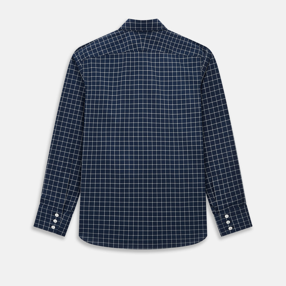 The Turnbull & Asser UK White Check on Navy Windsor Shirt features an open collar, button cuffs, and cuffed long sleeves. Showcased against a white background, this shirt presents a navy base adorned with a white grid pattern.