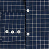 View 4 of product The Turnbull & Asser UK White Check on Navy Windsor Shirt features an open collar, button cuffs, and cuffed long sleeves. Showcased against a white background, this shirt presents a navy base adorned with a white grid pattern.