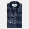 View 5 of product The Turnbull & Asser UK White Check on Navy Windsor Shirt features an open collar, button cuffs, and cuffed long sleeves. Showcased against a white background, this shirt presents a navy base adorned with a white grid pattern.