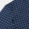 View 6 of product The Turnbull & Asser UK White Check on Navy Windsor Shirt features an open collar, button cuffs, and cuffed long sleeves. Showcased against a white background, this shirt presents a navy base adorned with a white grid pattern.