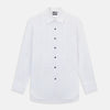 View 1 of product The Casino Royale White Dress Shirt in Cotton by Turnbull & Asser UK is a long-sleeve white dress shirt, crafted from crisp white cotton poplin with a pleated bib front, black buttons, and a classic collar, shown laid flat on a white background.