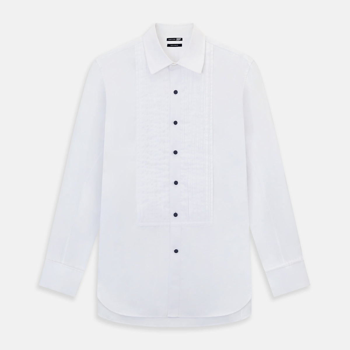 View 1 of product The Casino Royale White Dress Shirt in Cotton by Turnbull & Asser UK is a long-sleeve white dress shirt, crafted from crisp white cotton poplin with a pleated bib front, black buttons, and a classic collar, shown laid flat on a white background.