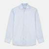 View 1 of product The Turnbull & Asser Tailored Fit Light Blue Cotton Shirt features a Kent collar, buttoned front, and 3-button cuffs, ideal for pairing with a navy suit and shown laid flat on a white background.