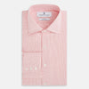 View 5 of product The Turnbull & Asser UK CORAL COTTON MINI CHECKED SHIRT is a light pink long-sleeve button-up shirt with a Kent collar, white buttons, and three-button cuffs, shown on a plain white background.
