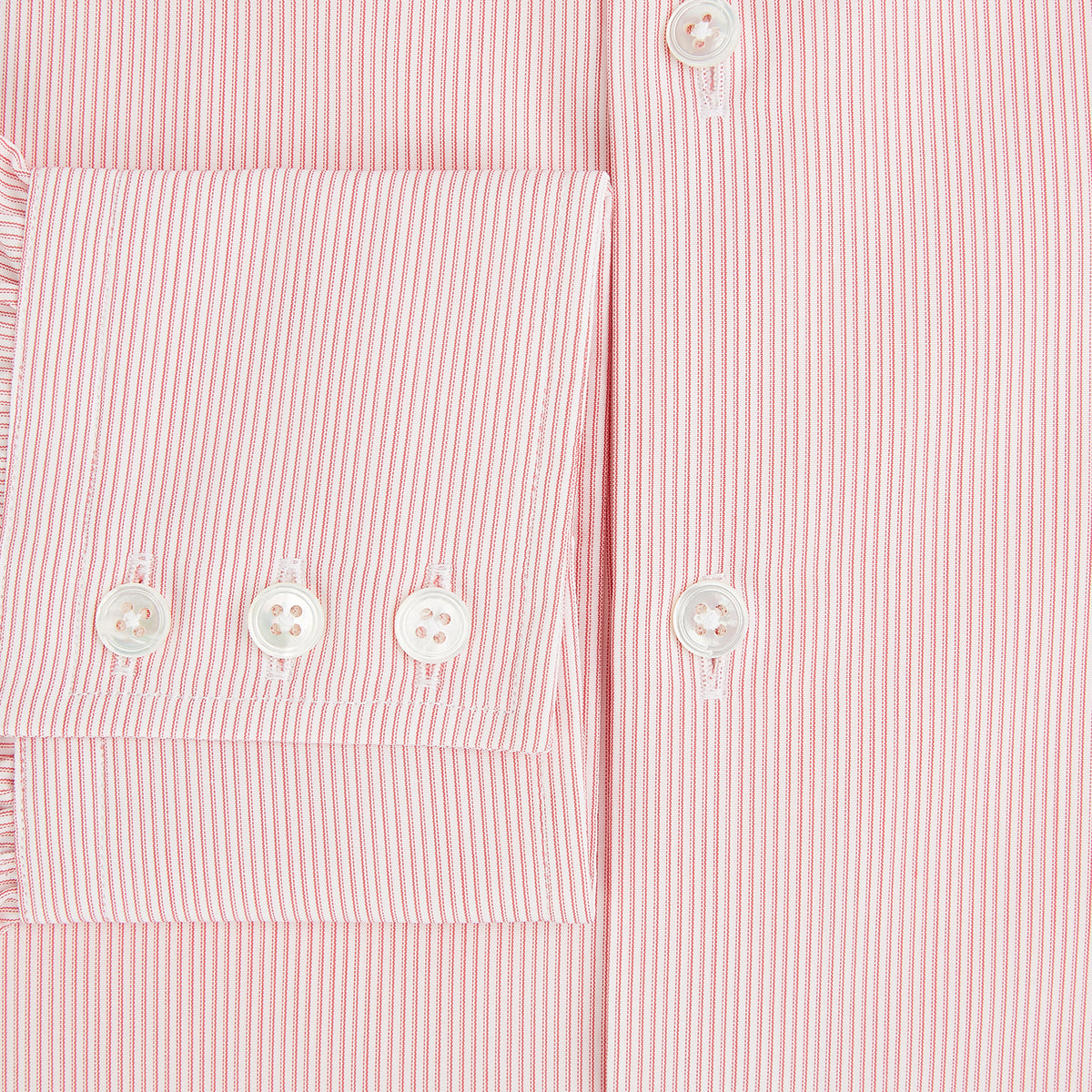 View 3 of product The Fine Striped Coral on White Tailored Fit Shirt in Cotton by Turnbull & Asser UK is a light pink long-sleeve button-up dress shirt with a collar, featuring subtle coral stripe detailing, displayed flat against a white background.