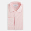 View 4 of product The Fine Striped Coral on White Tailored Fit Shirt in Cotton by Turnbull & Asser UK is a light pink long-sleeve button-up dress shirt with a collar, featuring subtle coral stripe detailing, displayed flat against a white background.