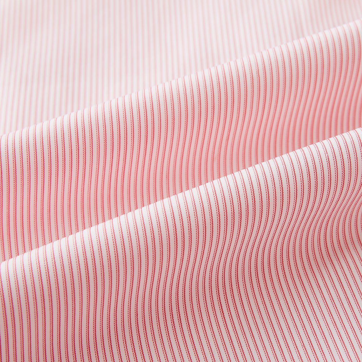 View 5 of product The Fine Striped Coral on White Tailored Fit Shirt in Cotton by Turnbull & Asser UK is a light pink long-sleeve button-up dress shirt with a collar, featuring subtle coral stripe detailing, displayed flat against a white background.