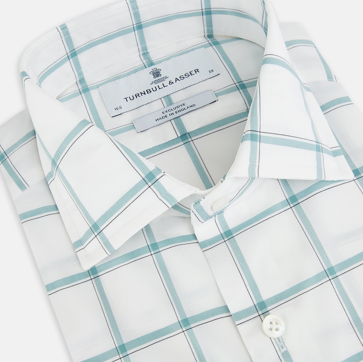 View 2 of product The Turnbull & Asser UK Large Checked Sage on White Tailored Fit Shirt in Cotton features white, long sleeves and button-up styling with a subtle sage check and light gray windowpane plaid pattern, neatly laid flat against a white background.