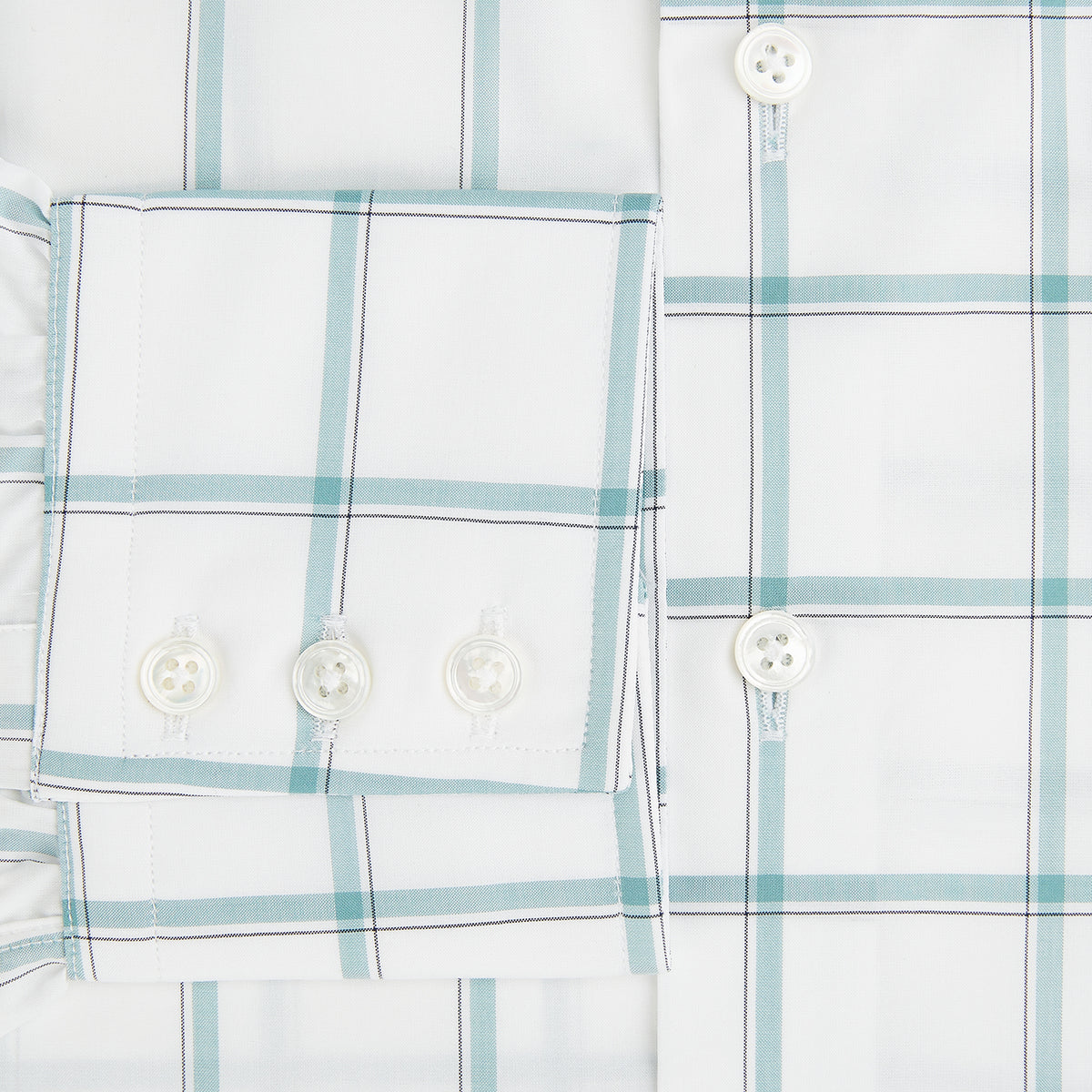 View 4 of product The Turnbull & Asser UK Large Checked Sage on White Tailored Fit Shirt in Cotton features white, long sleeves and button-up styling with a subtle sage check and light gray windowpane plaid pattern, neatly laid flat against a white background.
