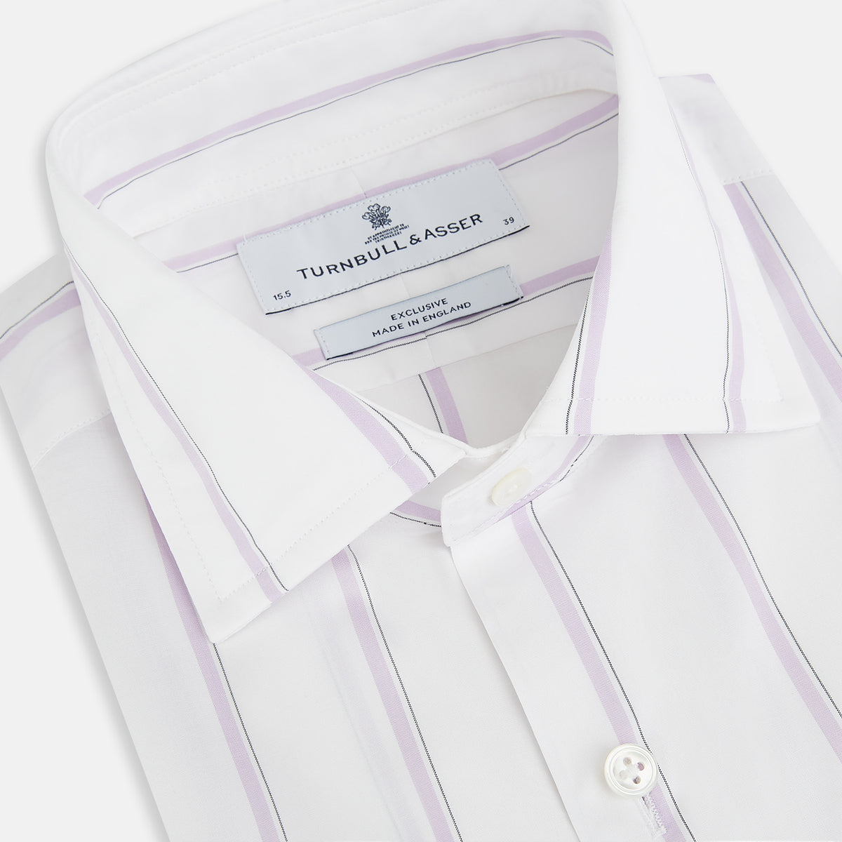 View 2 of product Track Striped Pink on White Tailored Fit Shirt in Cotton by Turnbull & Asser UK, featuring thin vertical pink stripes on white cotton, a classic collar, slim tailored fit, and buttoned cuffs, displayed on a plain white background.