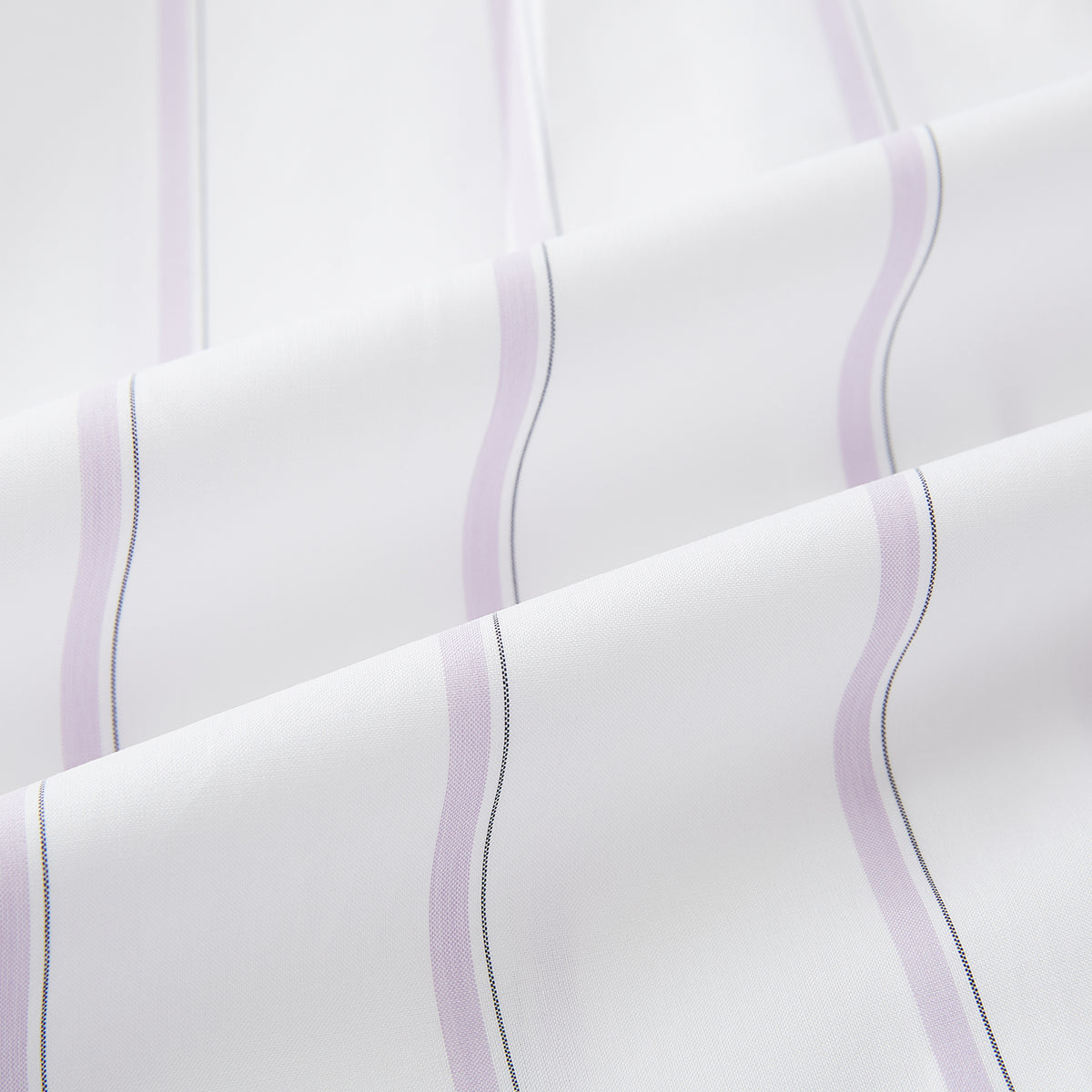 View 6 of product Track Striped Pink on White Tailored Fit Shirt in Cotton by Turnbull & Asser UK, featuring thin vertical pink stripes on white cotton, a classic collar, slim tailored fit, and buttoned cuffs, displayed on a plain white background.