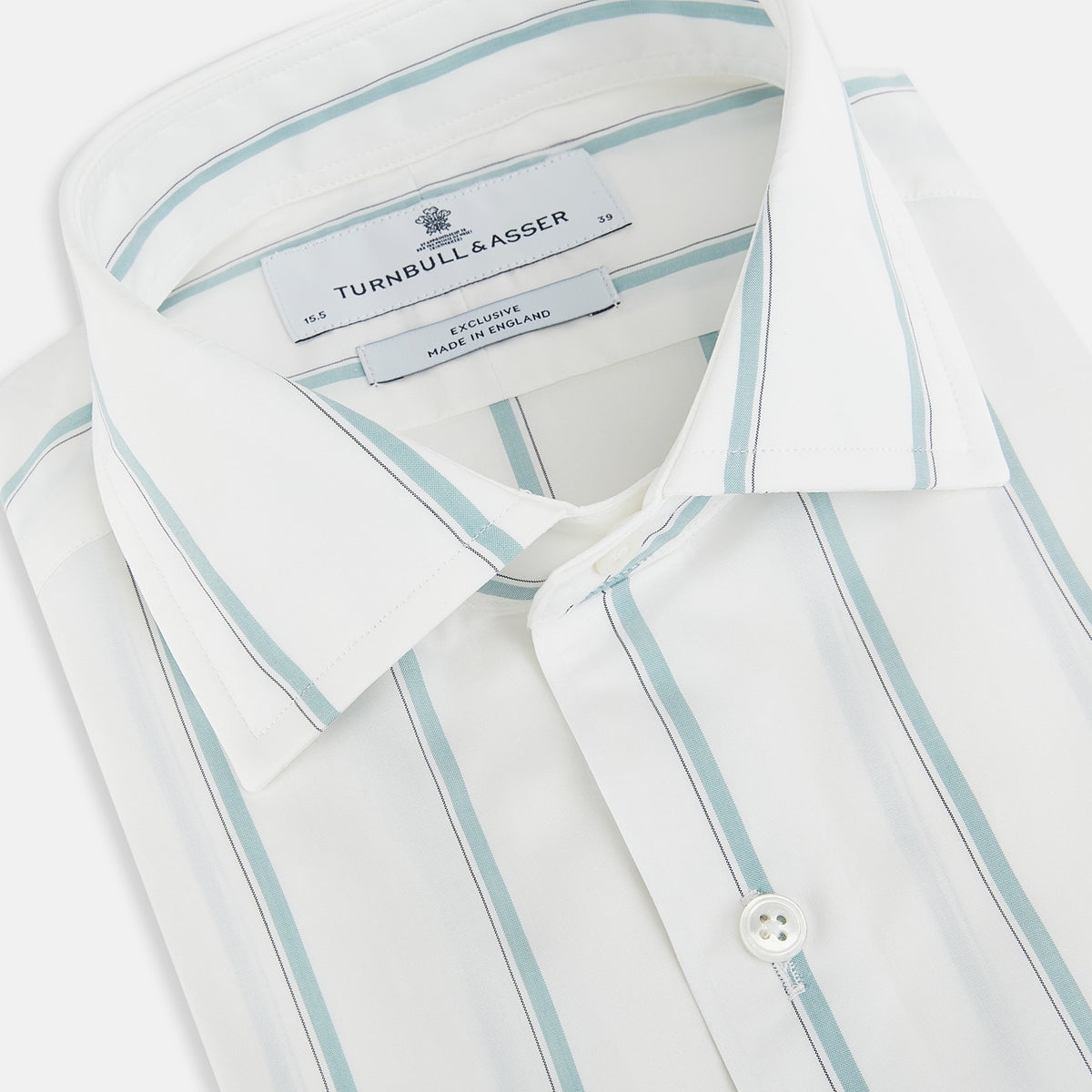 View 2 of product Track Striped Sage on White Tailored Fit Shirt in Cotton by Turnbull & Asser UK, featuring light blue vertical stripes, a classic collar, and cuffed long sleeves, displayed laid flat against a plain white background.
