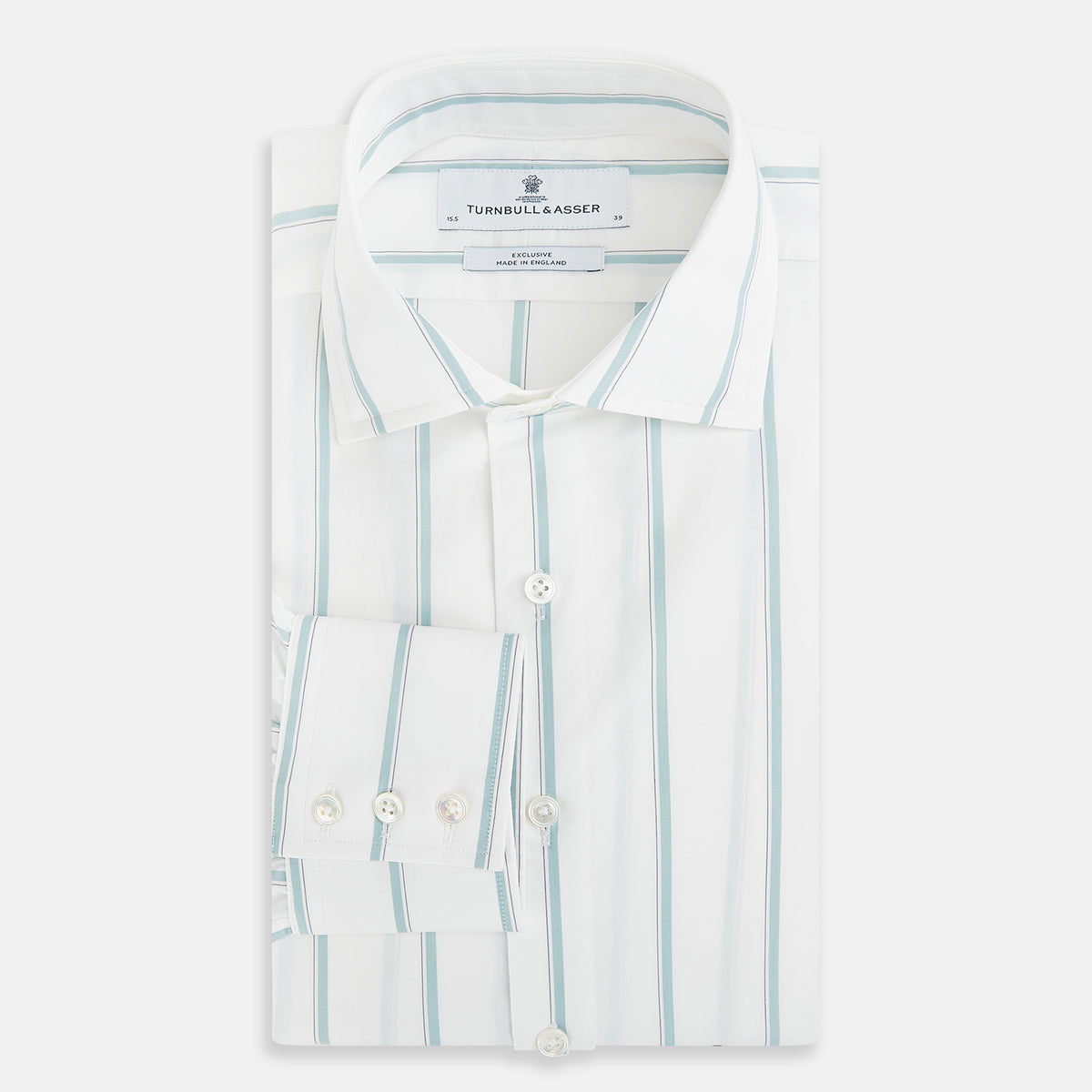 View 5 of product Track Striped Sage on White Tailored Fit Shirt in Cotton by Turnbull & Asser UK, featuring light blue vertical stripes, a classic collar, and cuffed long sleeves, displayed laid flat against a plain white background.