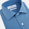 View 2 of product The Turnbull & Asser UK SHIRTS NEW TF KENT CLR 3BC COLONY BLUE/NAVY STRIPE is a long-sleeve button-up dress shirt featuring a pointed Kent collar, white buttons, and buttoned cuffs, shown against a plain white background.