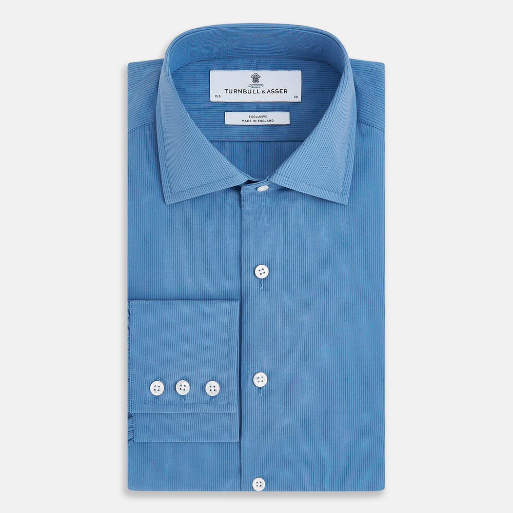 The Turnbull & Asser UK SHIRTS NEW TF KENT CLR 3BC COLONY BLUE/NAVY STRIPE is a long-sleeve button-up dress shirt featuring a pointed Kent collar, white buttons, and buttoned cuffs, shown against a plain white background.