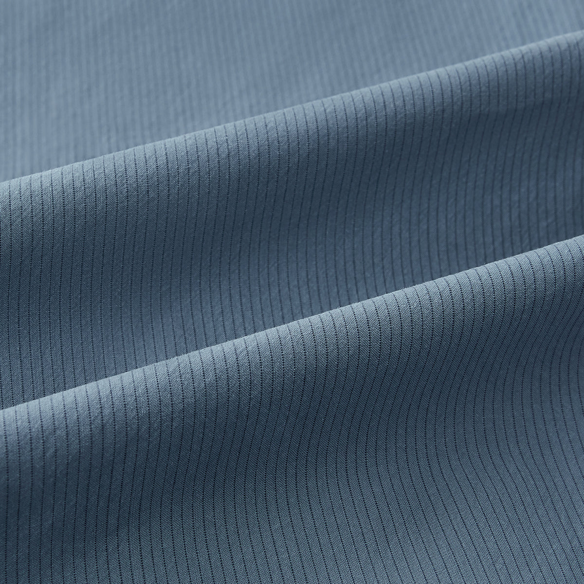View 7 of product A long-sleeved, button-down Kent collar shirt by Turnbull & Asser UK, featuring a steel gray and navy stripe pattern, displayed on a plain white background.