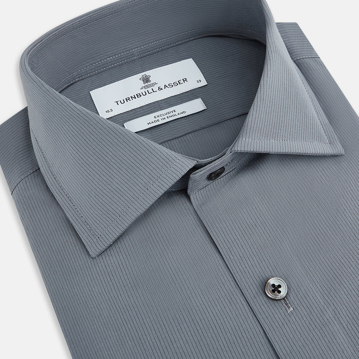 View 2 of product A long-sleeve, button-up men’s dress shirt by Turnbull & Asser UK, the SHIRTS NEW TF KENT CLR 3BC GRAY/NAVY STRIPE, featuring a pointed Kent collar and buttoned cuffs in a gray and navy stripe pattern, displayed against a plain white background.