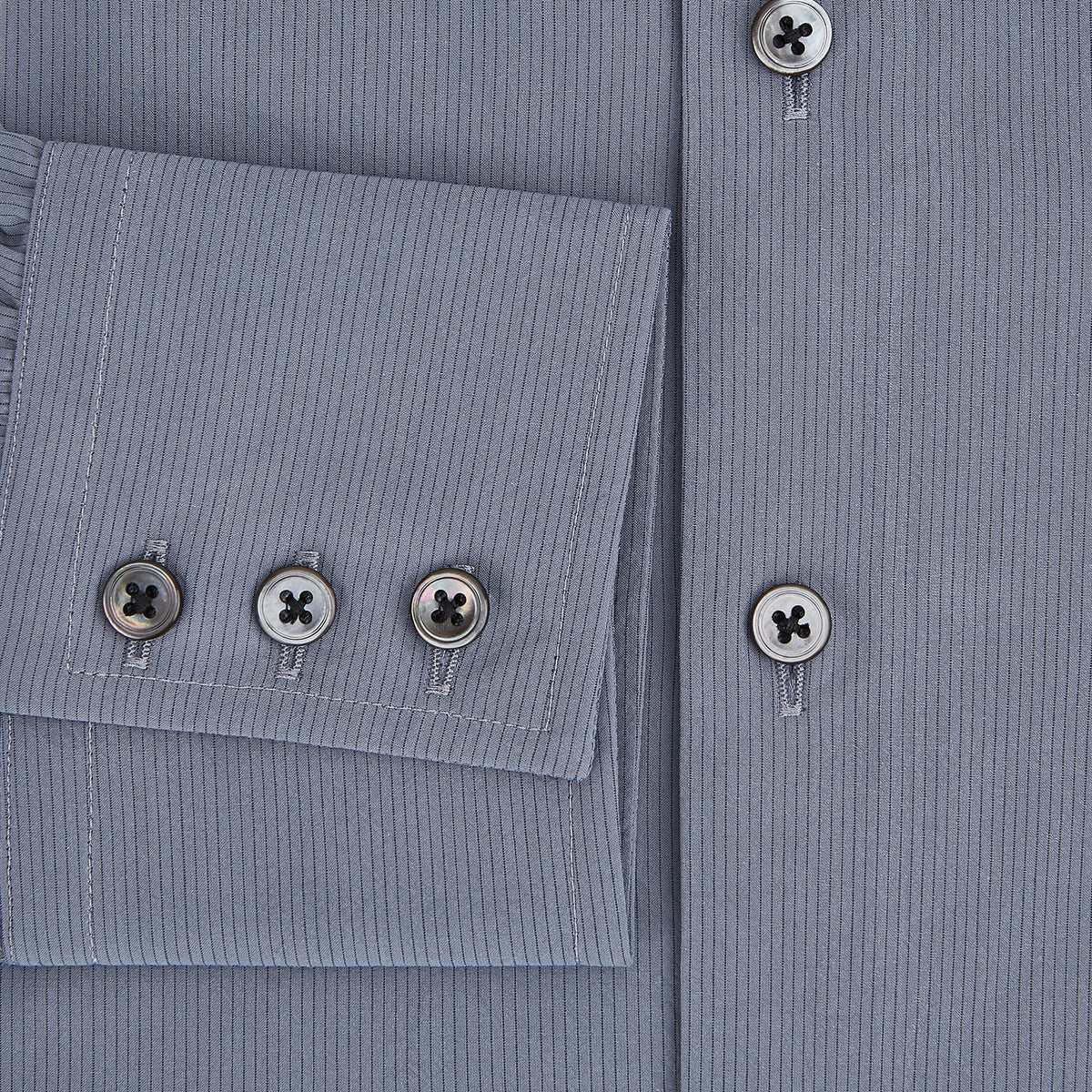 View 4 of product A long-sleeve, button-up men’s dress shirt by Turnbull & Asser UK, the SHIRTS NEW TF KENT CLR 3BC GRAY/NAVY STRIPE, featuring a pointed Kent collar and buttoned cuffs in a gray and navy stripe pattern, displayed against a plain white background.