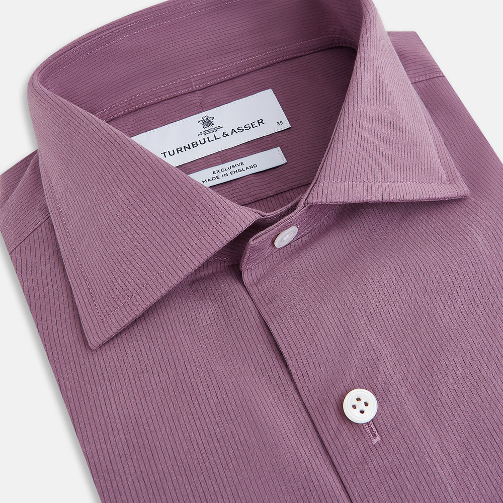 Displayed on a plain white background is the Turnbull & Asser UK Pinstriped Antique Pink Tailored Fit Shirt in Cotton, featuring long sleeves, a button-up front with crisp white buttons, and a classic kent collar in a refined mauve hue.