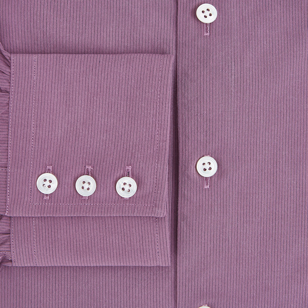 Displayed on a plain white background is the Turnbull & Asser UK Pinstriped Antique Pink Tailored Fit Shirt in Cotton, featuring long sleeves, a button-up front with crisp white buttons, and a classic kent collar in a refined mauve hue.