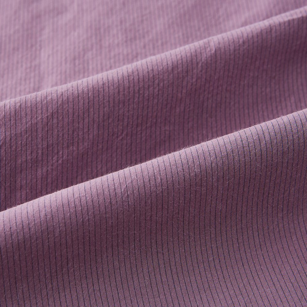 Displayed on a plain white background is the Turnbull & Asser UK Pinstriped Antique Pink Tailored Fit Shirt in Cotton, featuring long sleeves, a button-up front with crisp white buttons, and a classic kent collar in a refined mauve hue.