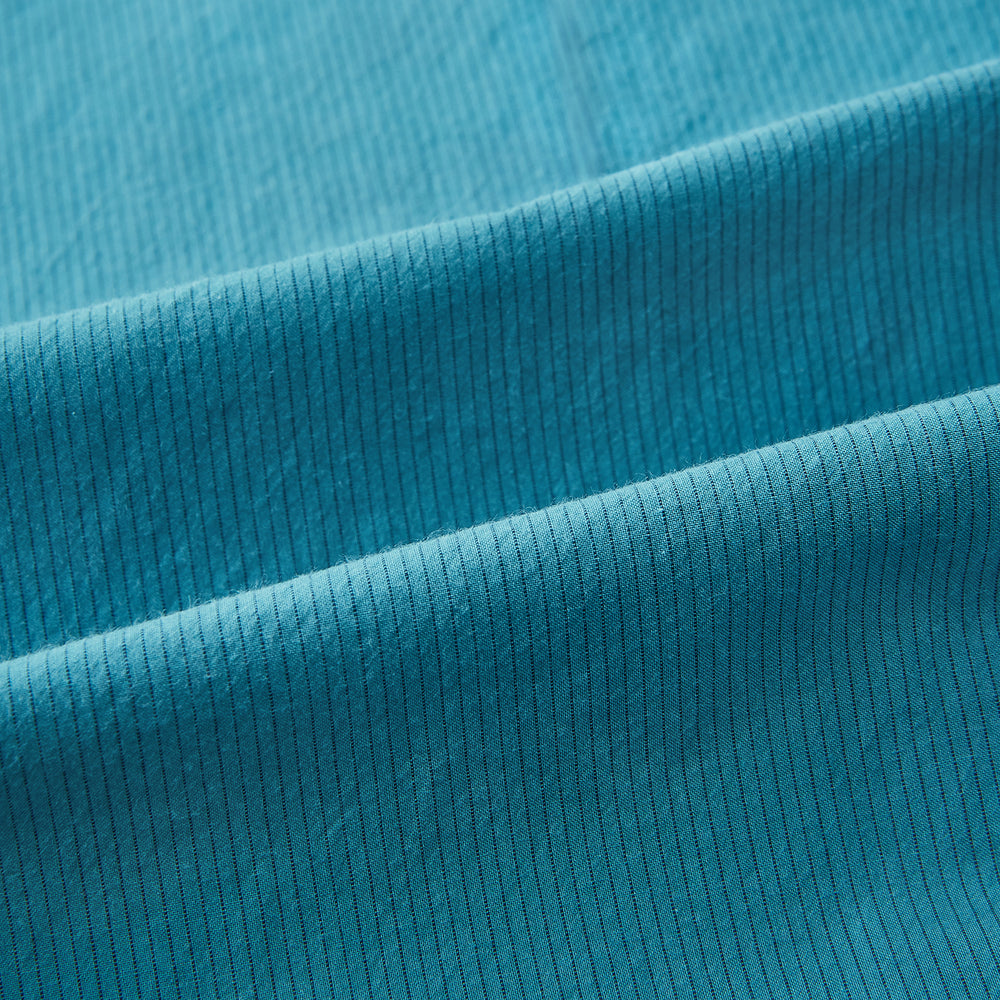 A Pinstriped Turquoise Tailored Fit Shirt in Cotton by Turnbull & Asser UK, styled as a classic long-sleeve button-up with a classic collar, white buttons, and buttoned cuffs—evoking the refined craftsmanship of traditional Turnbull & Asser shirts—displayed laid flat on a white background.