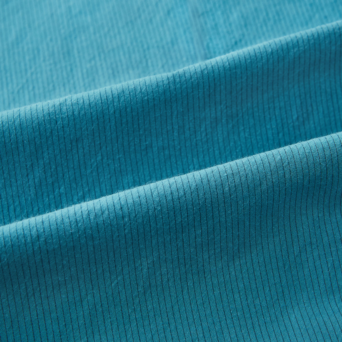 View 6 of product A Pinstriped Turquoise Tailored Fit Shirt in Cotton by Turnbull & Asser UK, styled as a classic long-sleeve button-up with a classic collar, white buttons, and buttoned cuffs—evoking the refined craftsmanship of traditional Turnbull & Asser shirts—displayed laid flat on a white background.