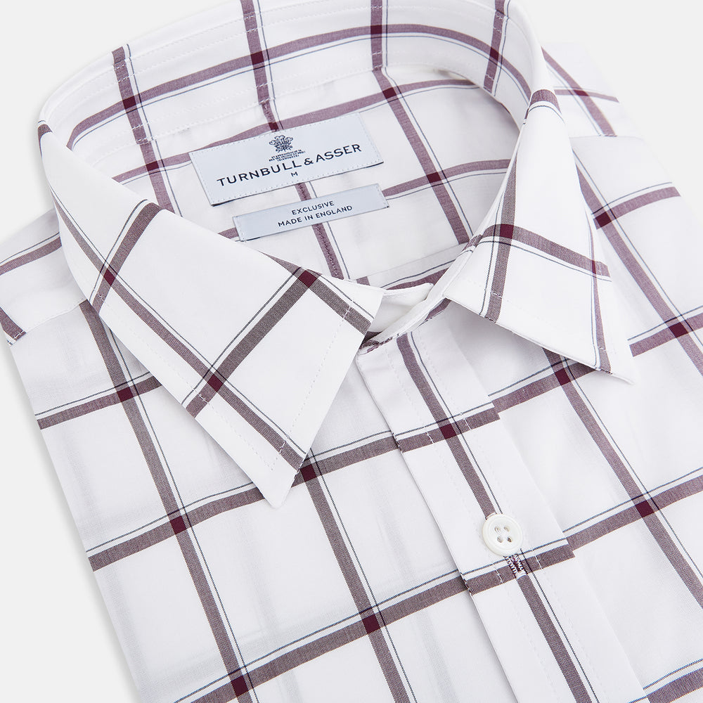 A Turnbull & Asser UK SHIRTS WF DERBY COLLAR 1BC 1PKT WHT/BURG MULTI CHK—a long-sleeve, button-up shirt in white with a burgundy multi-check pattern, featuring a classic derby collar and a single front pocket on the left side.