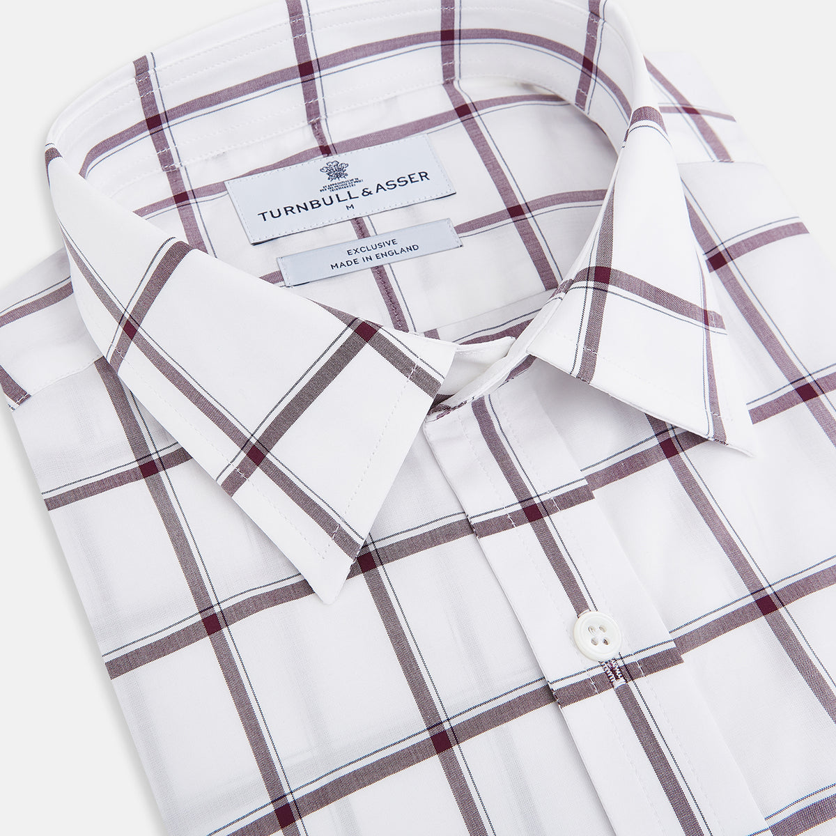 View 2 of product A Turnbull & Asser UK SHIRTS WF DERBY COLLAR 1BC 1PKT WHT/BURG MULTI CHK—a long-sleeve, button-up shirt in white with a burgundy multi-check pattern, featuring a classic derby collar and a single front pocket on the left side.