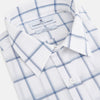 View 2 of product Large Checked Grey on White Weekend Fit Shirt in Cotton by Turnbull & Asser UK, featuring a white long-sleeve button-up design with a grey windowpane check pattern, front chest pocket, pointed derby collar, and buttoned cuffs, displayed flat on a plain white background.