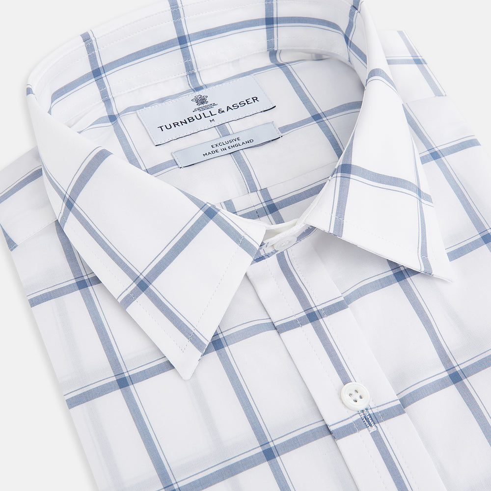 Large Checked Grey on White Weekend Fit Shirt in Cotton by Turnbull & Asser UK, featuring a white long-sleeve button-up design with a grey windowpane check pattern, front chest pocket, pointed derby collar, and buttoned cuffs, displayed flat on a plain white background.