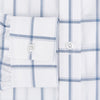 View 4 of product Large Checked Grey on White Weekend Fit Shirt in Cotton by Turnbull & Asser UK, featuring a white long-sleeve button-up design with a grey windowpane check pattern, front chest pocket, pointed derby collar, and buttoned cuffs, displayed flat on a plain white background.