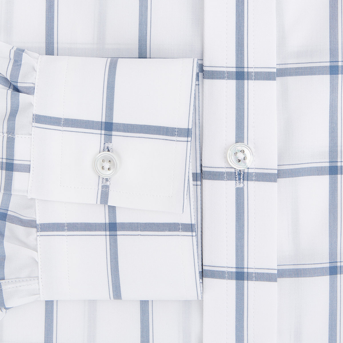 View 4 of product Large Checked Grey on White Weekend Fit Shirt in Cotton by Turnbull & Asser UK, featuring a white long-sleeve button-up design with a grey windowpane check pattern, front chest pocket, pointed derby collar, and buttoned cuffs, displayed flat on a plain white background.