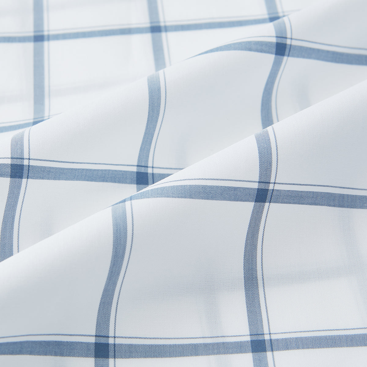 View 6 of product Large Checked Grey on White Weekend Fit Shirt in Cotton by Turnbull & Asser UK, featuring a white long-sleeve button-up design with a grey windowpane check pattern, front chest pocket, pointed derby collar, and buttoned cuffs, displayed flat on a plain white background.