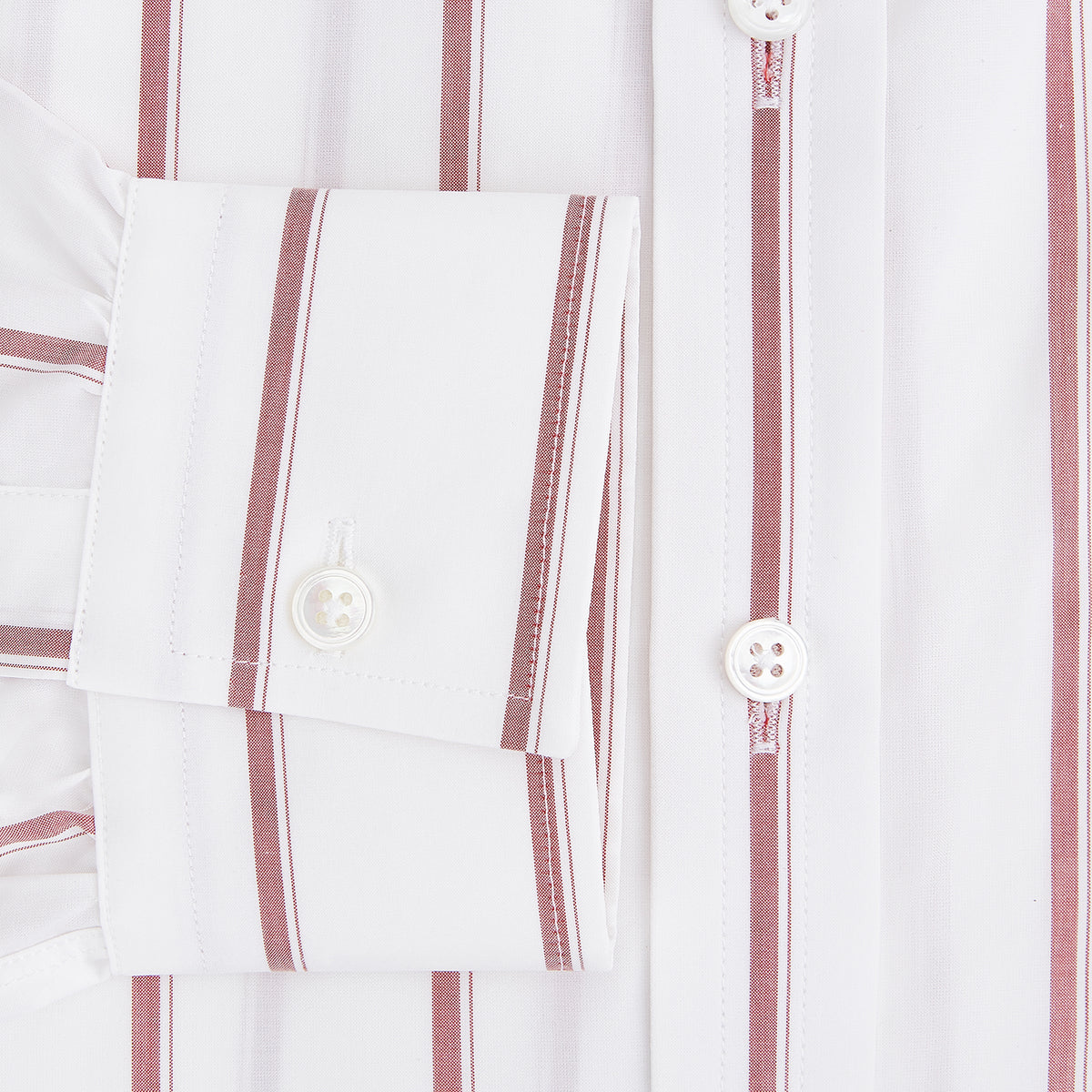View 4 of product The Turnbull & Asser UK Track Striped Red on White Weekend Fit Shirt in Cotton features bold dark red stripes on a crisp white base, with long sleeves, a derby collar, front chest pocket, and buttoned cuffs, laid flat on a white background for a timeless men’s dress shirt aesthetic.