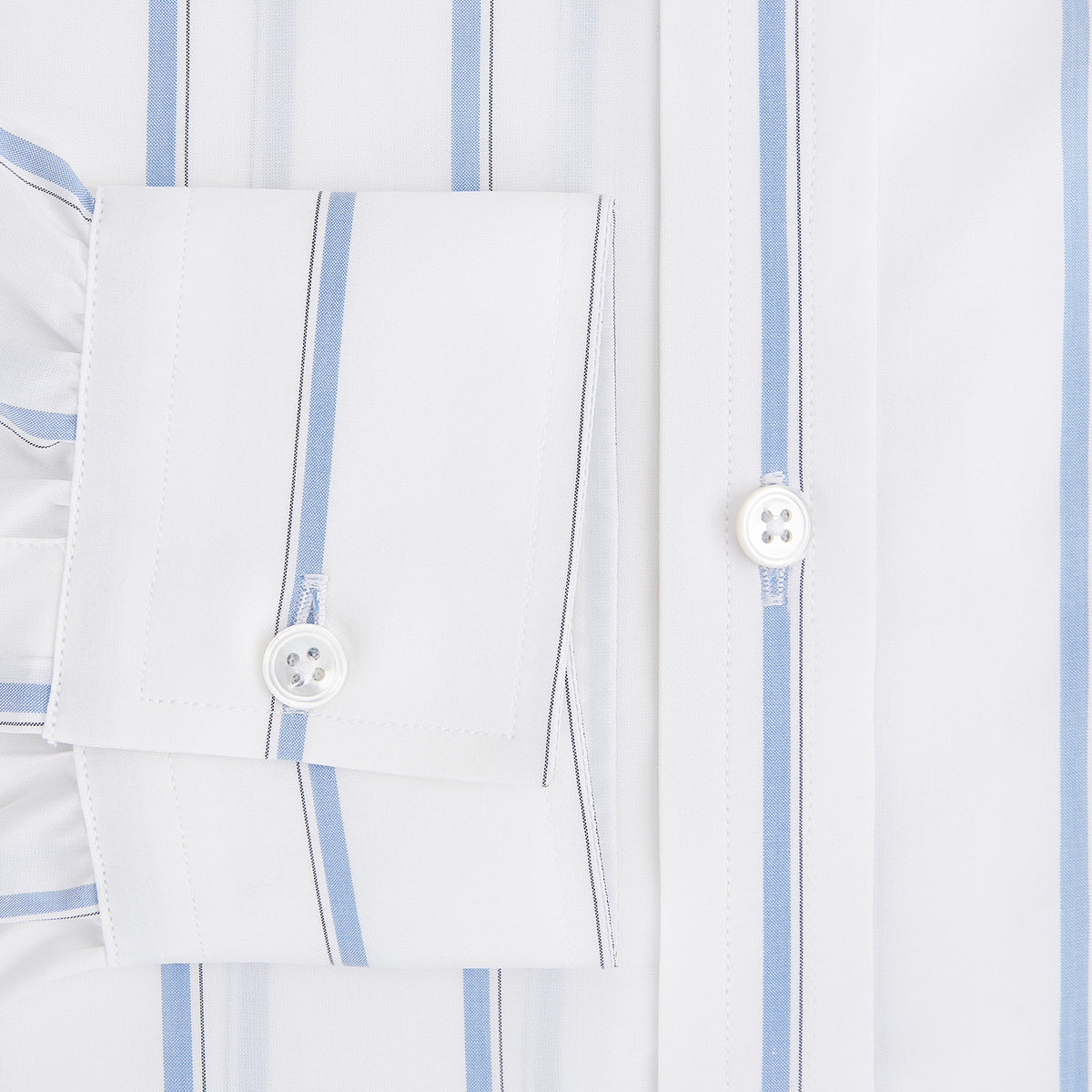 View 4 of product The Turnbull & Asser UK Track Striped Blue on White Weekend Fit Shirt in Cotton is a long-sleeve, button-up shirt featuring blue stripes on premium white Italian cotton, a Derby collar, and a chest pocket, elegantly laid flat against a white background.