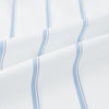 View 6 of product The Turnbull & Asser UK Track Striped Blue on White Weekend Fit Shirt in Cotton is a long-sleeve, button-up shirt featuring blue stripes on premium white Italian cotton, a Derby collar, and a chest pocket, elegantly laid flat against a white background.