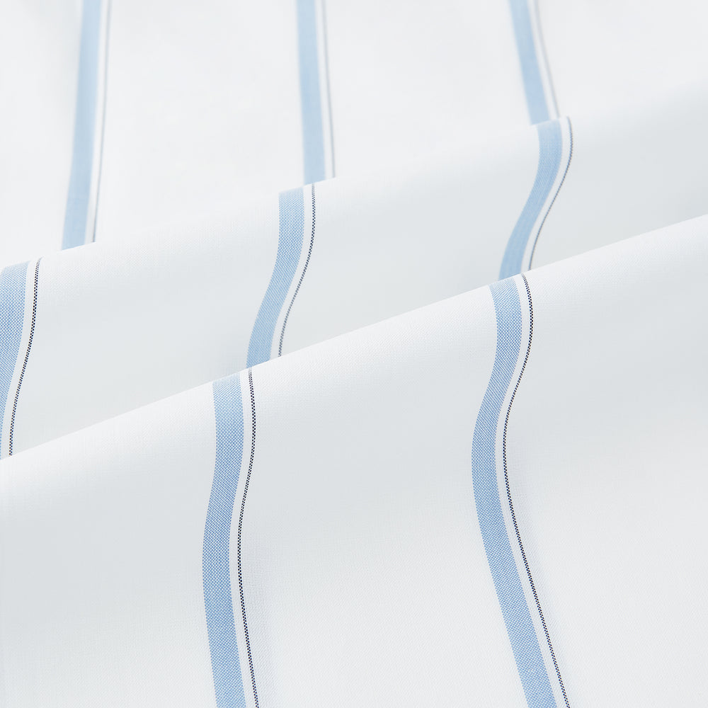 The Turnbull & Asser UK Track Striped Blue on White Weekend Fit Shirt in Cotton is a long-sleeve, button-up shirt featuring blue stripes on premium white Italian cotton, a Derby collar, and a chest pocket, elegantly laid flat against a white background.