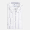 View 5 of product Introducing the Track Striped Grey on White Weekend Fit Shirt in Cotton by Turnbull & Asser UK—a men’s long-sleeve dress shirt crafted from crisp white cotton, featuring vertical grey stripes, a button-down front, derby collar, cuffs, and a chest pocket. The shirt is displayed laid flat on a white surface.