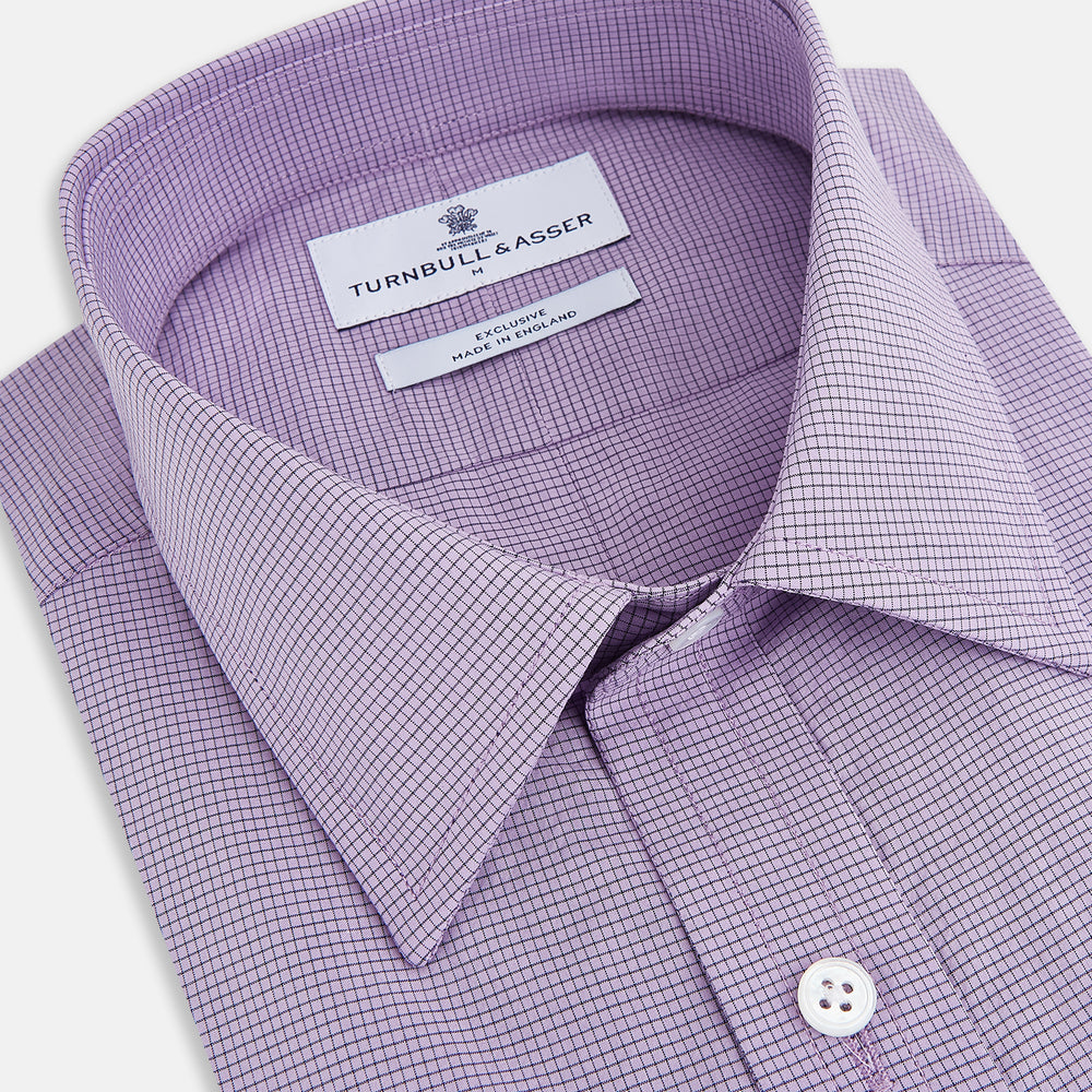 A long-sleeved, button-up Fine Checked Baby Pink Weekend Fit Shirt in Cotton by Turnbull & Asser UK, featuring a single chest pocket and a classic collar design, laid flat on a white background.